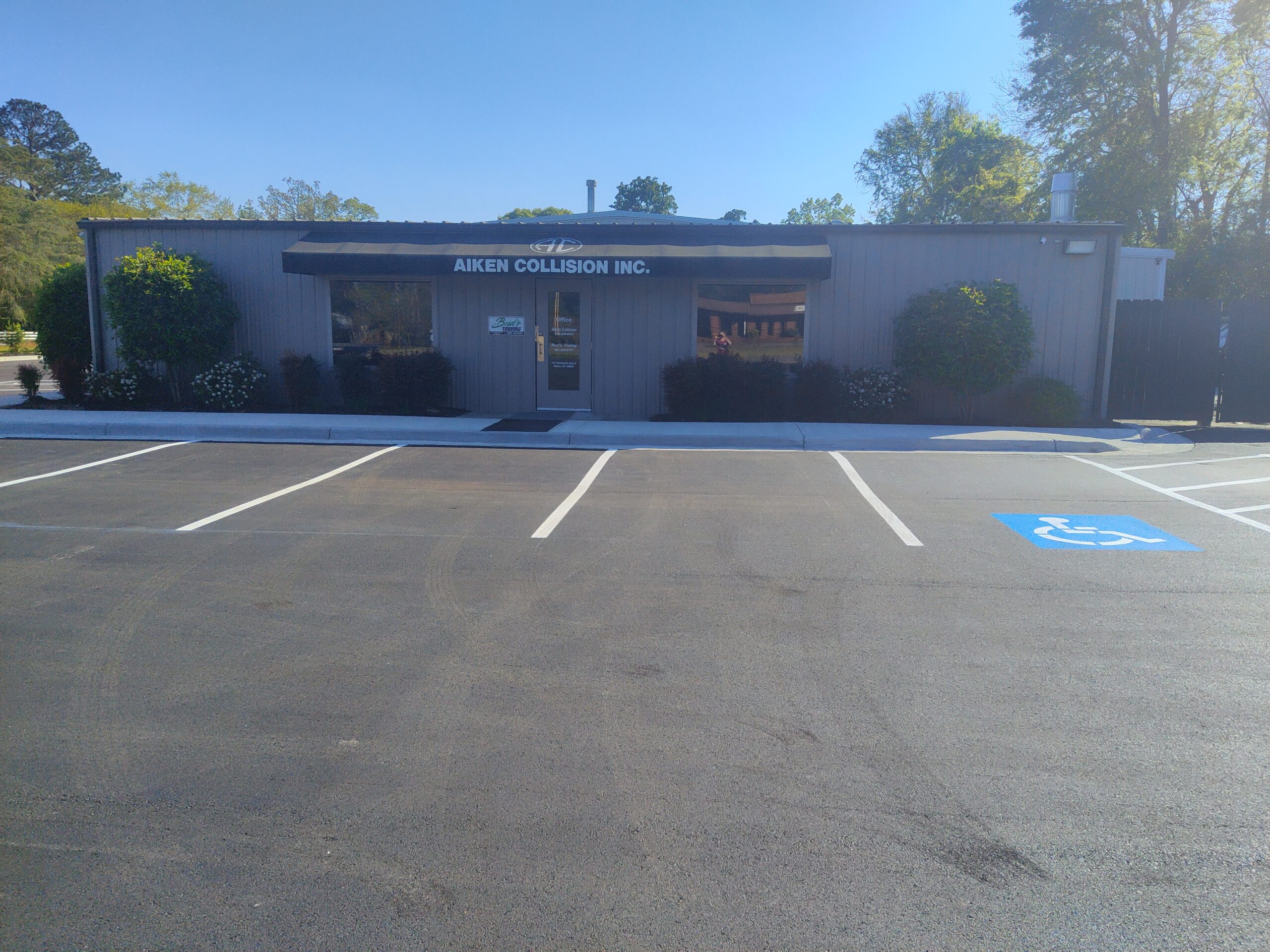 Front of Aiken Collision Repair Shop with the new paved parking lot